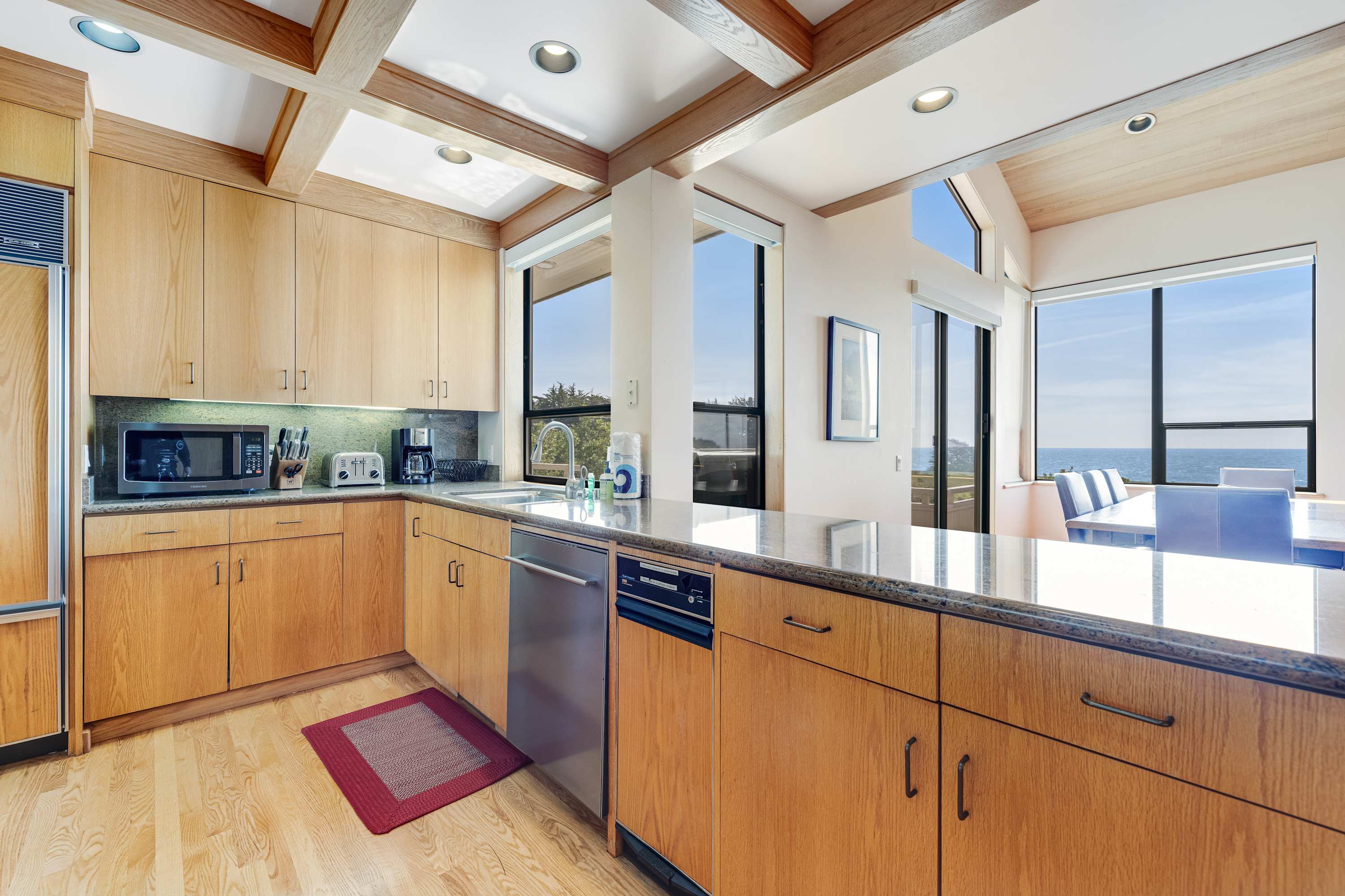 Enjoy effortless meal prep in this modern kitchen, where every detail enhances your cooking experience against a backdrop of ocean beauty.