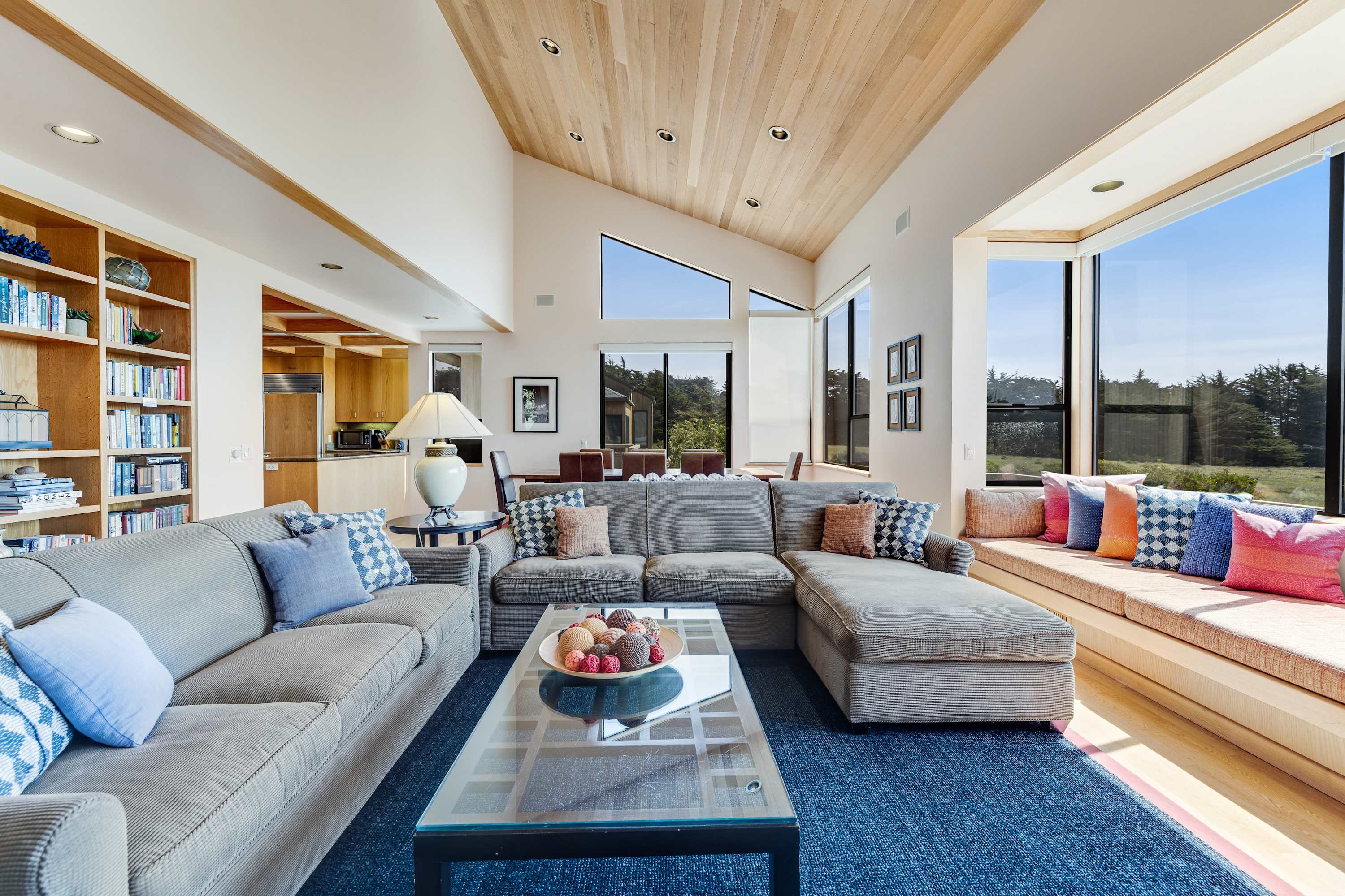 Gather in this inviting living room, where natural light pours in, creating the perfect atmosphere for cozy evenings by the wood-burning fireplace.