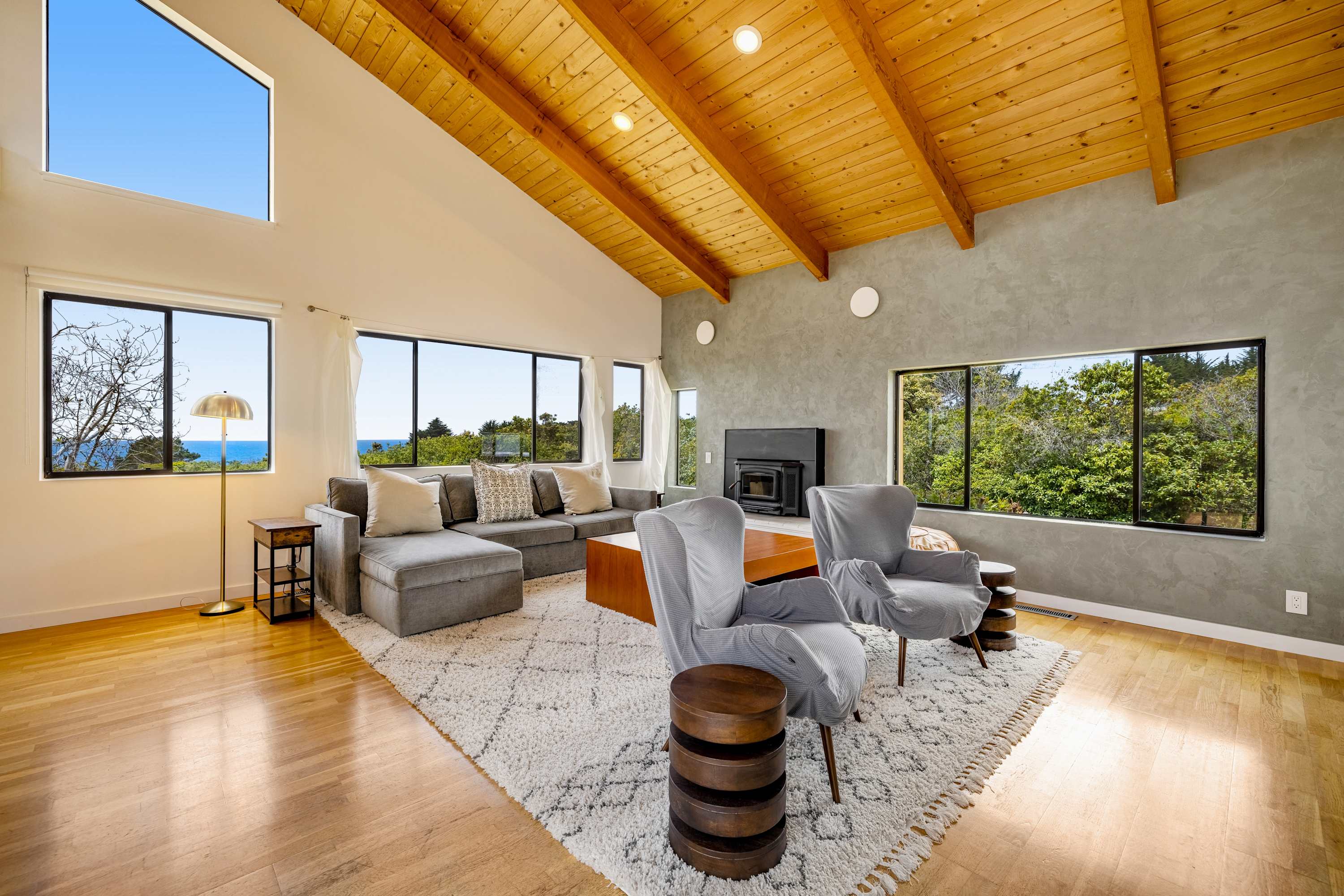 Morning light fills this spacious living room, inviting you to relax with a good book while the ocean view sets the perfect backdrop.