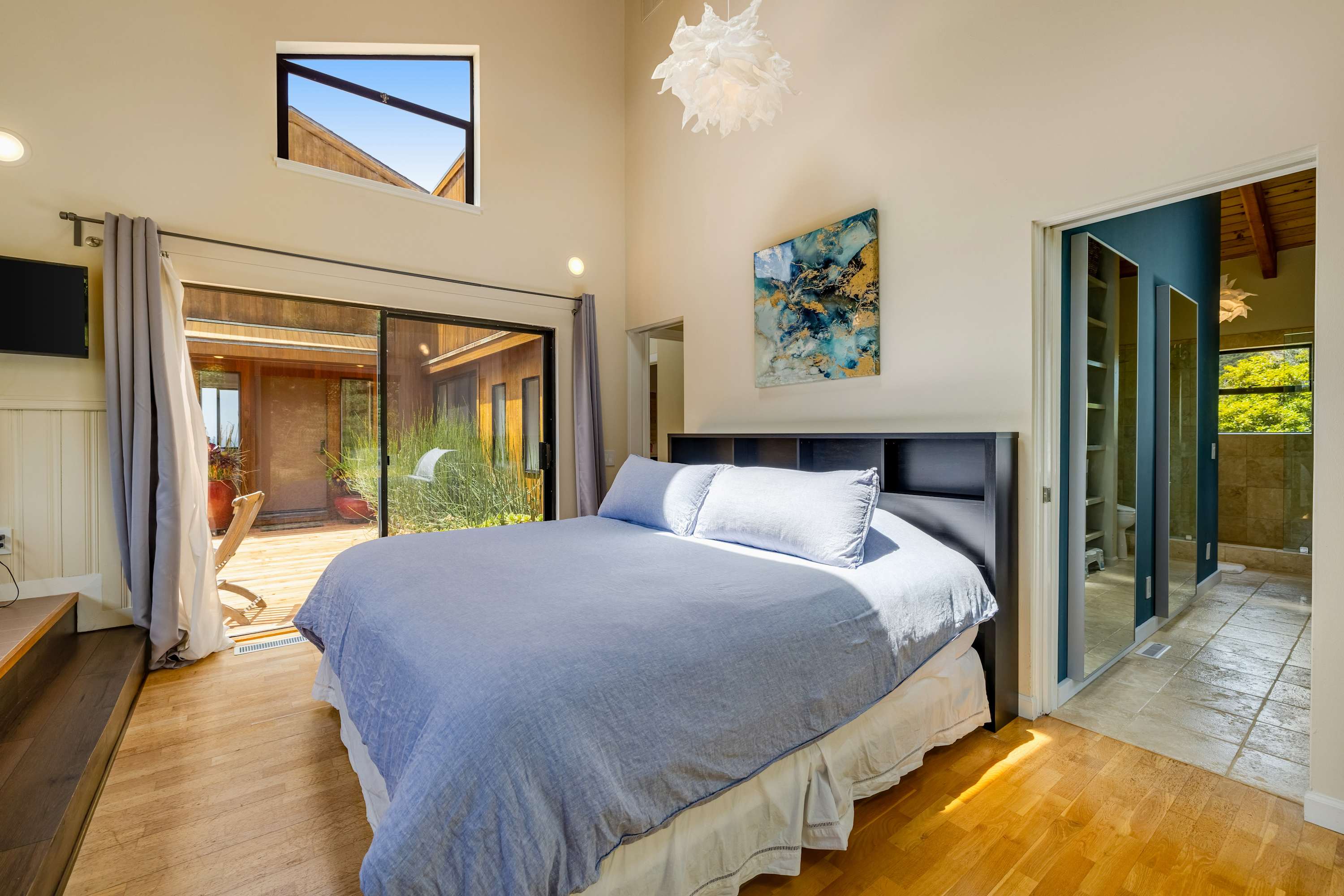 Awaken in the master bedroom, where large windows invite natural light and stunning views, creating a tranquil retreat for restful nights.