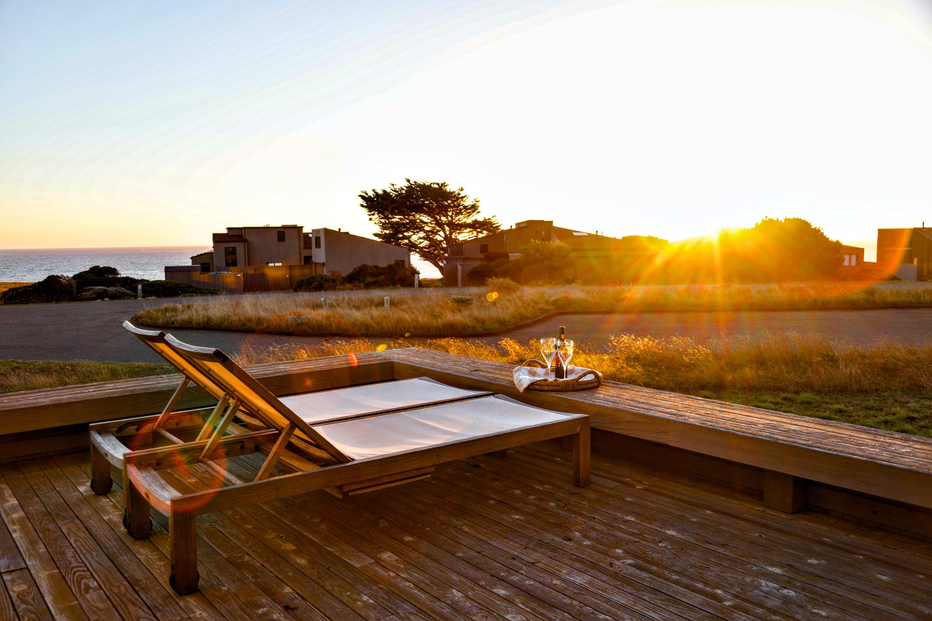 Pour a glass and settle into the deck lounge chairs — sunset over the meadow and Pacific is your evening show at Da Yaya House.
