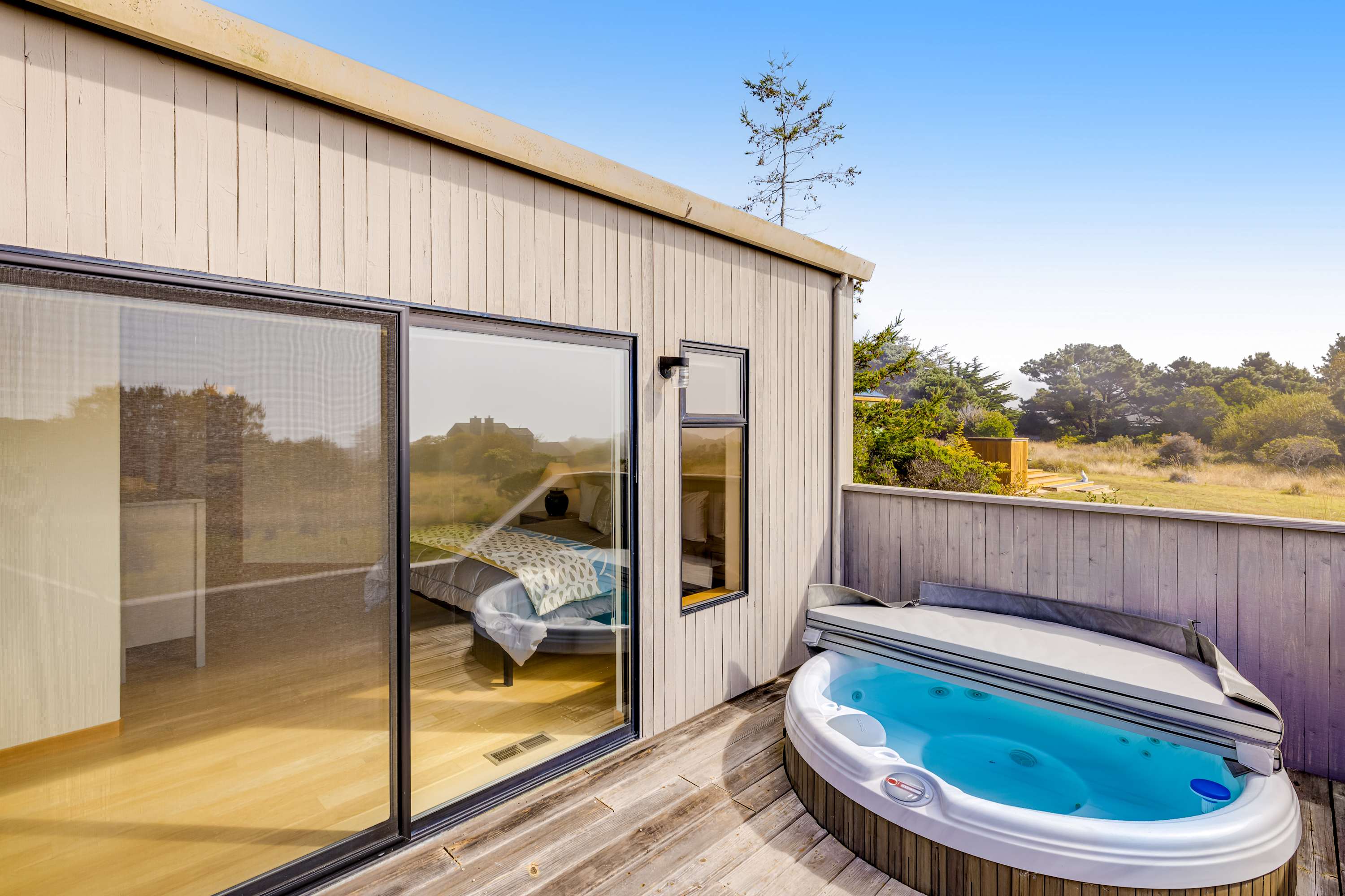 Relax in your private hot tub, surrounded by nature, the perfect spot to unwind after a day of coastal adventures.