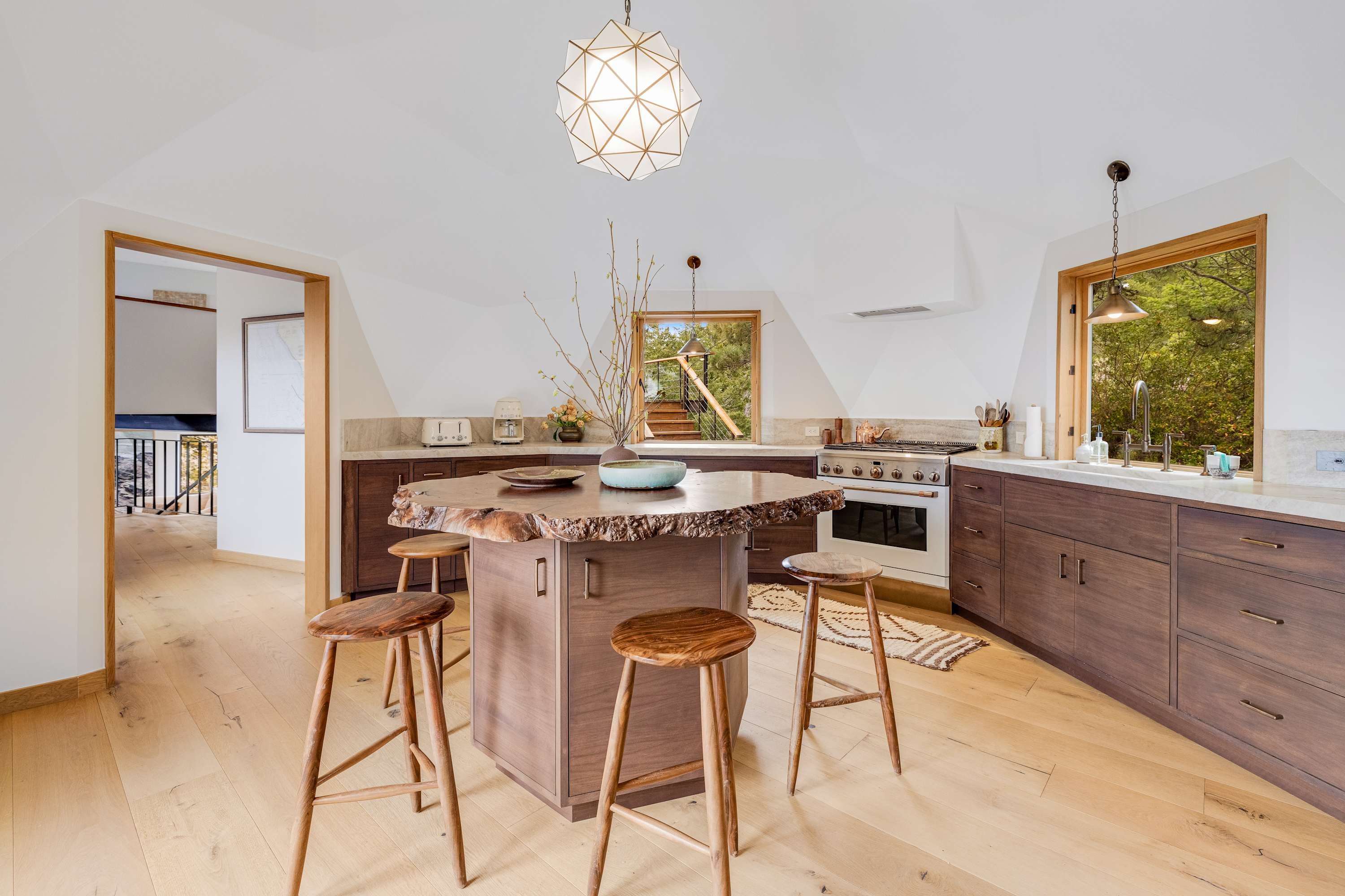 Gather around the unique island in this contemporary kitchen, an ideal spot for casual conversations while meals come to life.