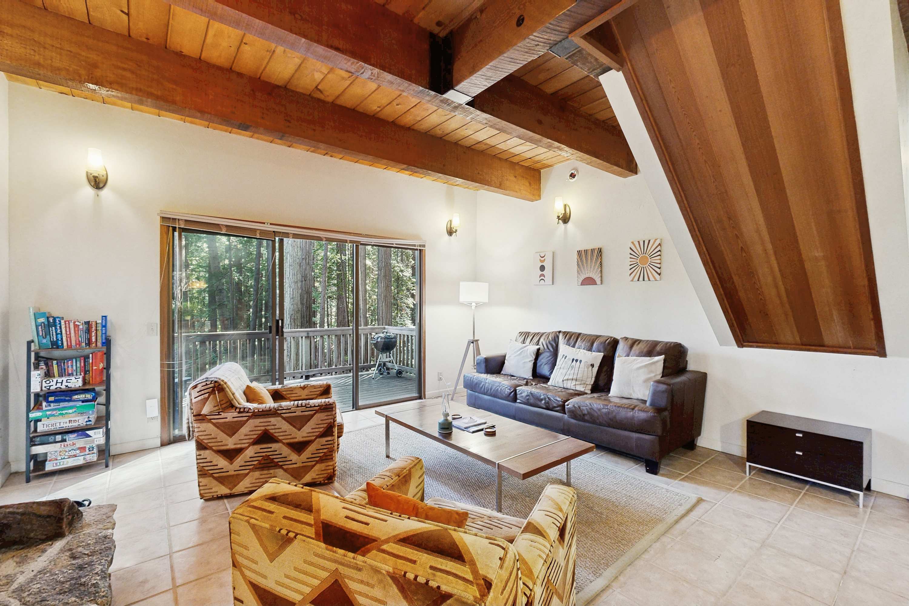 Bask in the warmth of the wood-burning fireplace while you unwind in this cozy living room, perfect for family gatherings or quiet evenings.