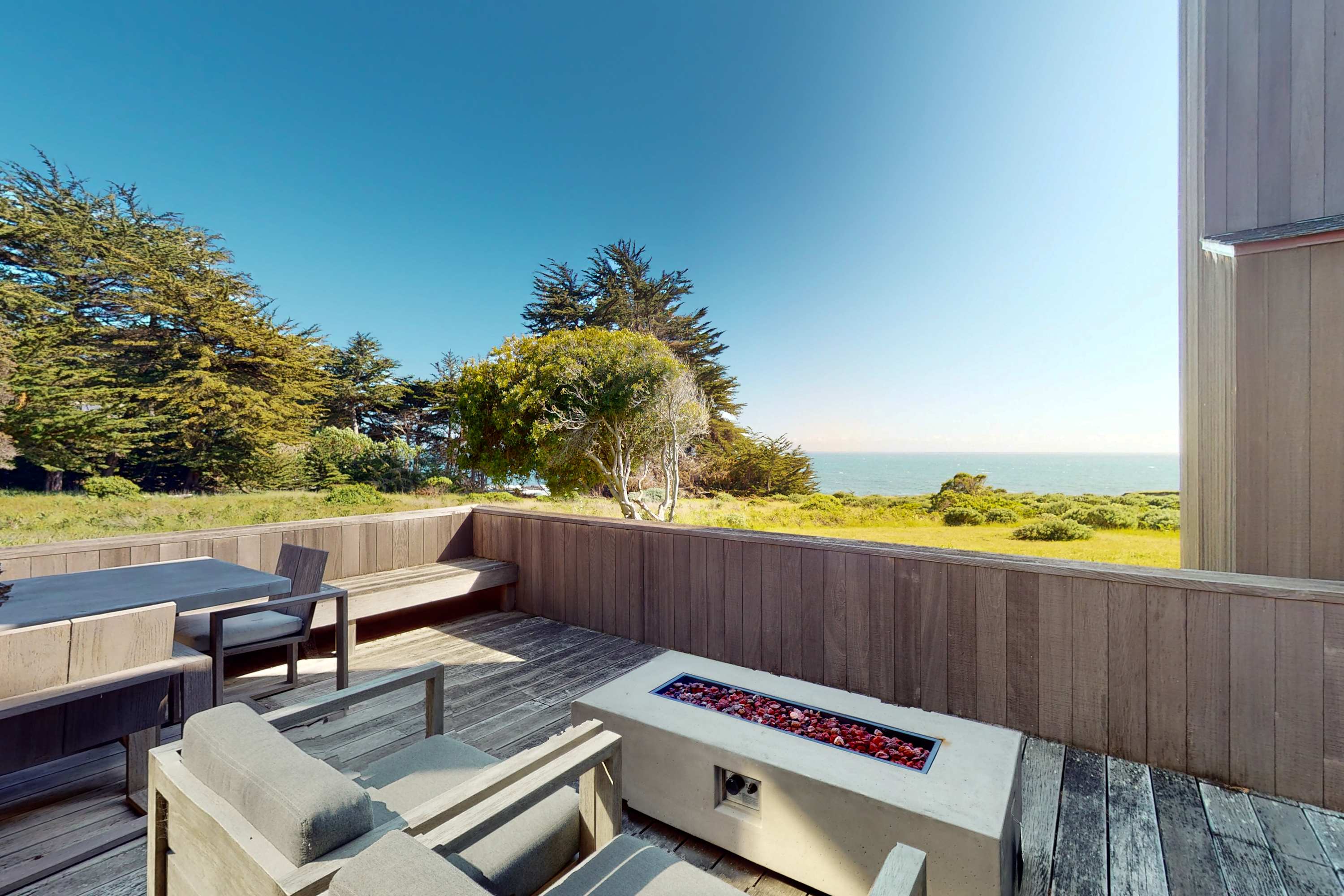 Step onto the deck and breathe in the fresh ocean air while lounging by the fire pit, perfect for evening gatherings under the stars.