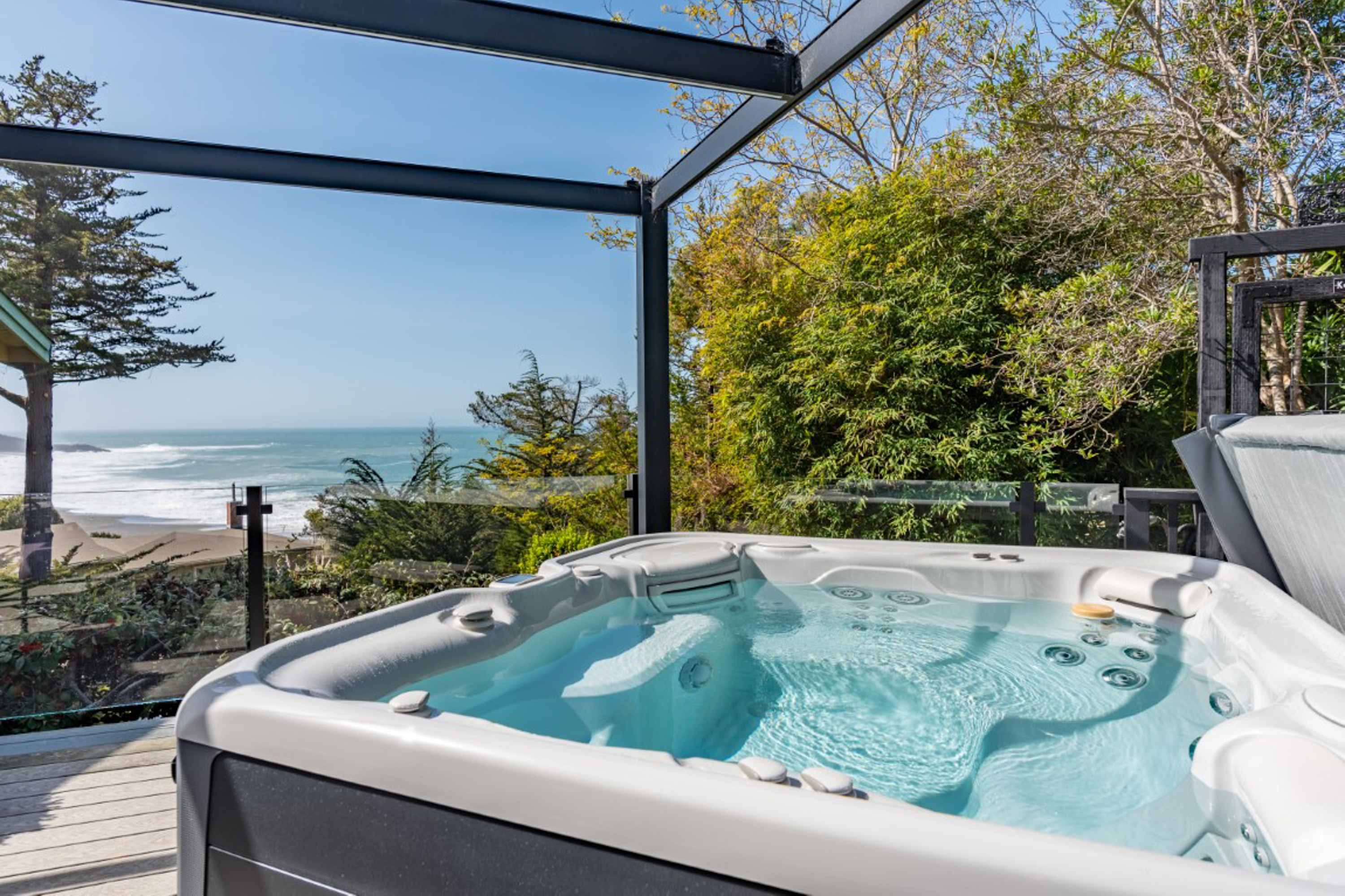 Soak in your private hot tub while gazing at the endless ocean views, the perfect way to unwind after a day of adventure.