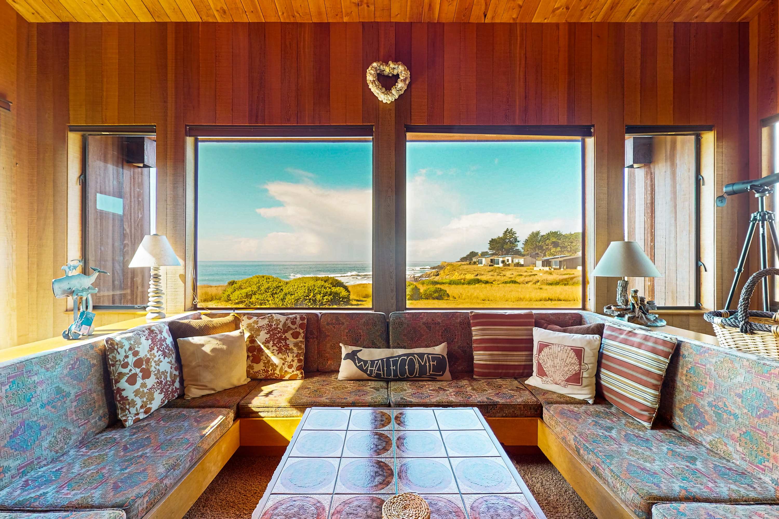 Feel the coastal charm as you relax on the inviting sofa, surrounded by panoramic views that make every moment special.