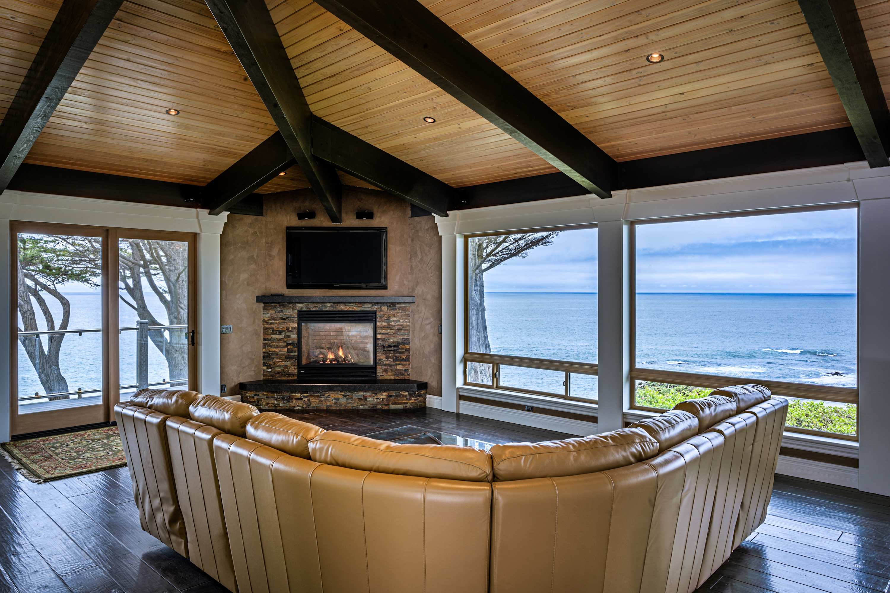 Gather around the cozy gas fireplace in the inviting living room, where comfort meets stunning ocean vistas.