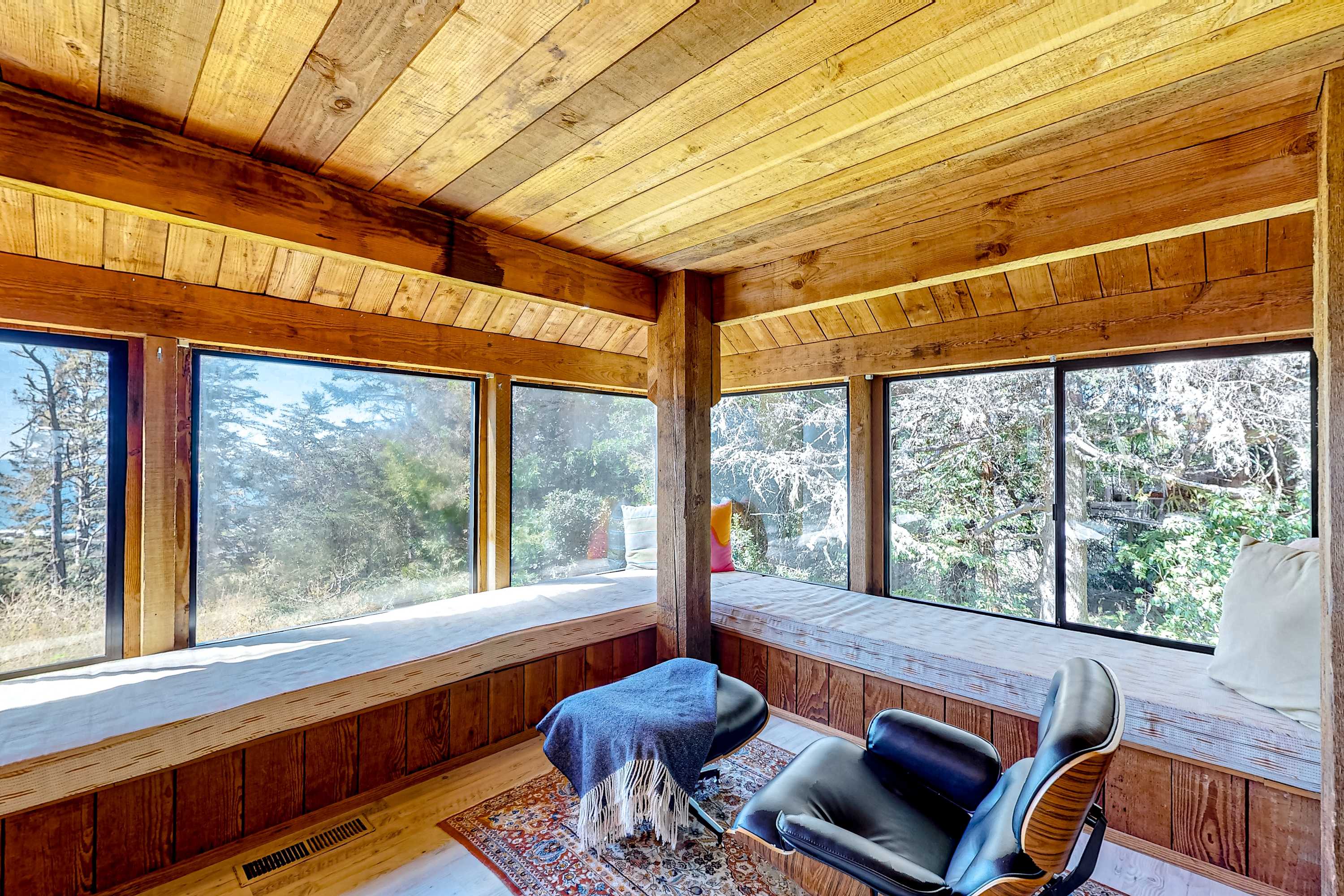 Imagine curling up with a good book on this sunny window seat, surrounded by the serene beauty of nature just outside.
