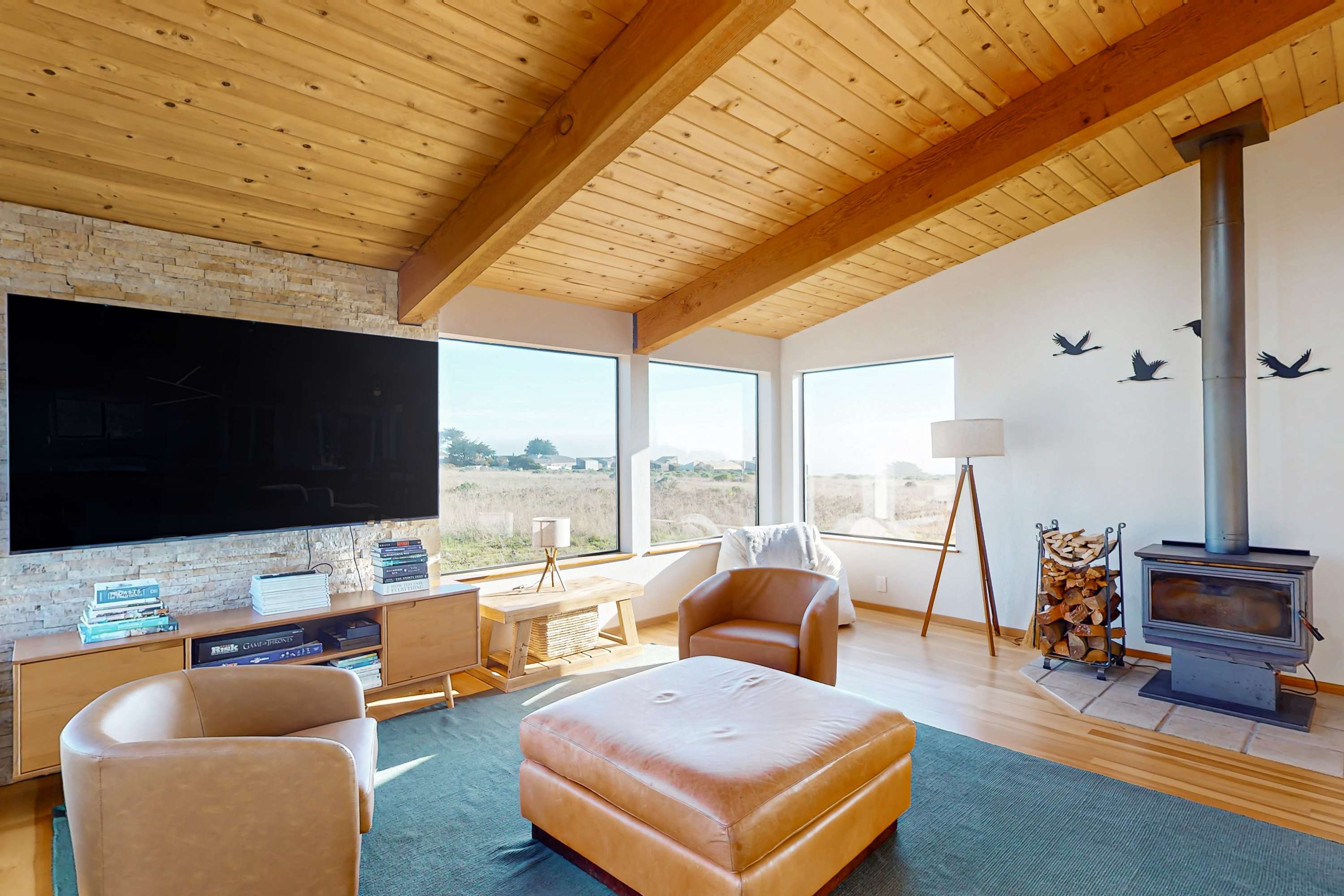 Picture yourself lounging in this sun-soaked living room, where comfort meets coastal charm and the ocean beckons just outside.