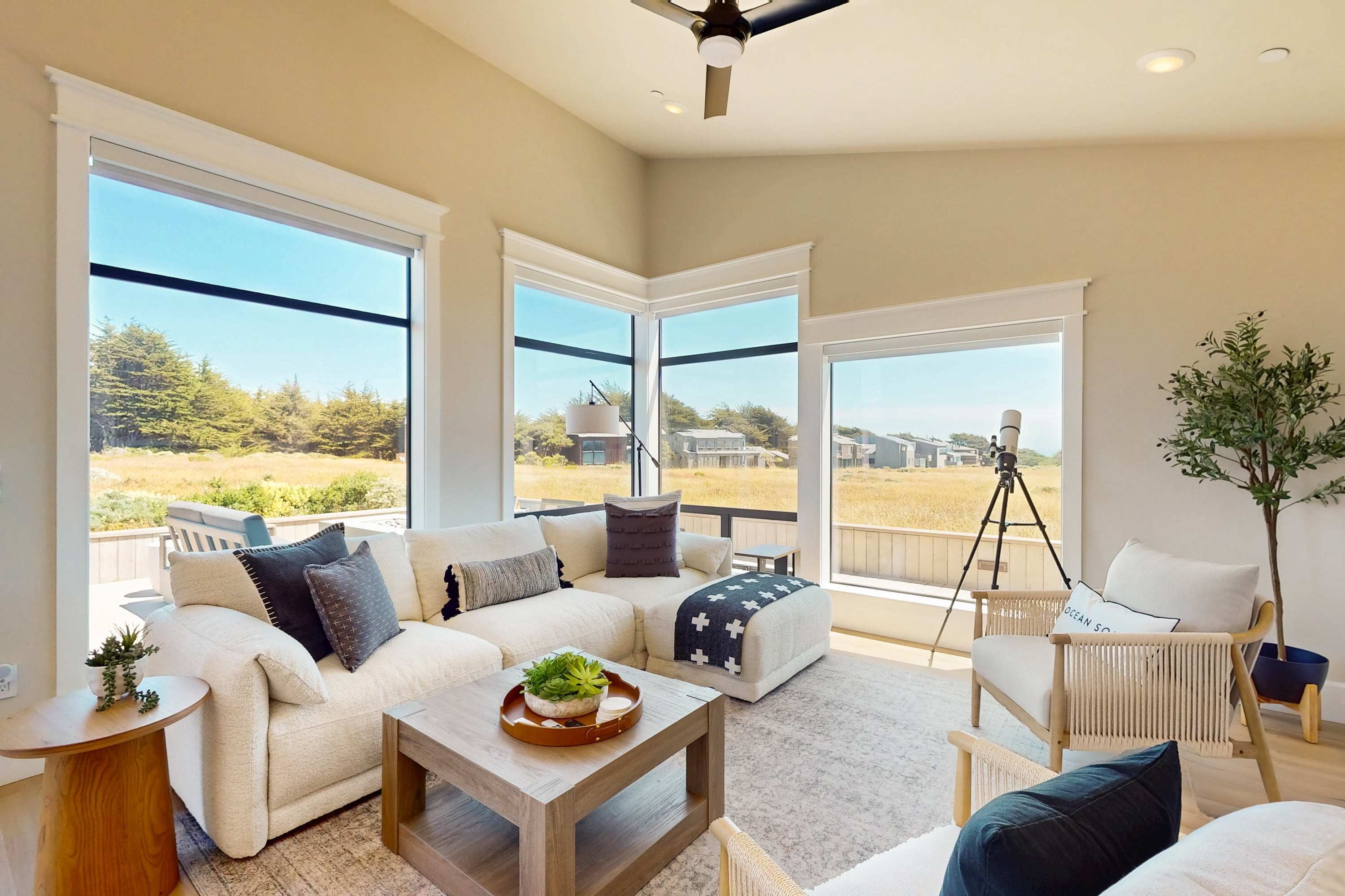 Morning light fills the living room, inviting you to sip coffee while gazing out at nature.