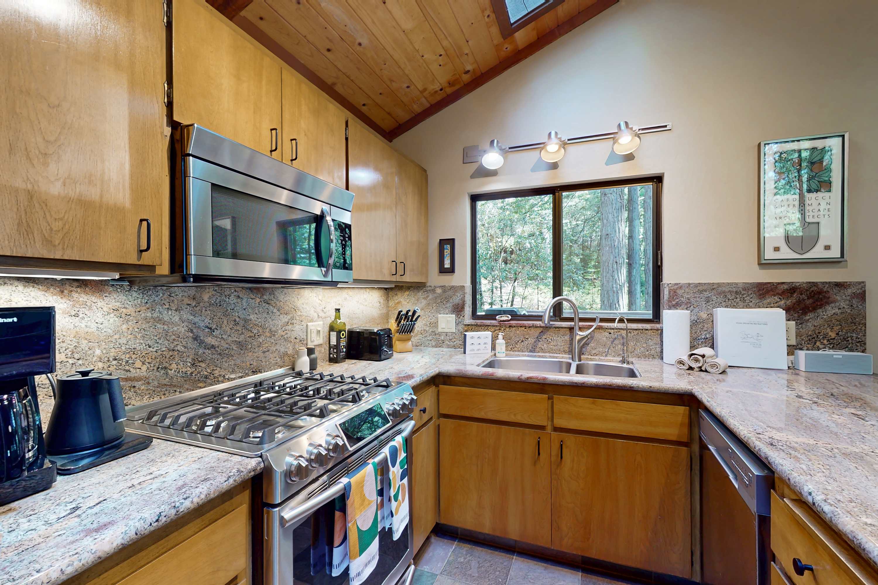 High-end appliances and ample counter space invite you to create your favorite dishes while enjoying the serene forest views.