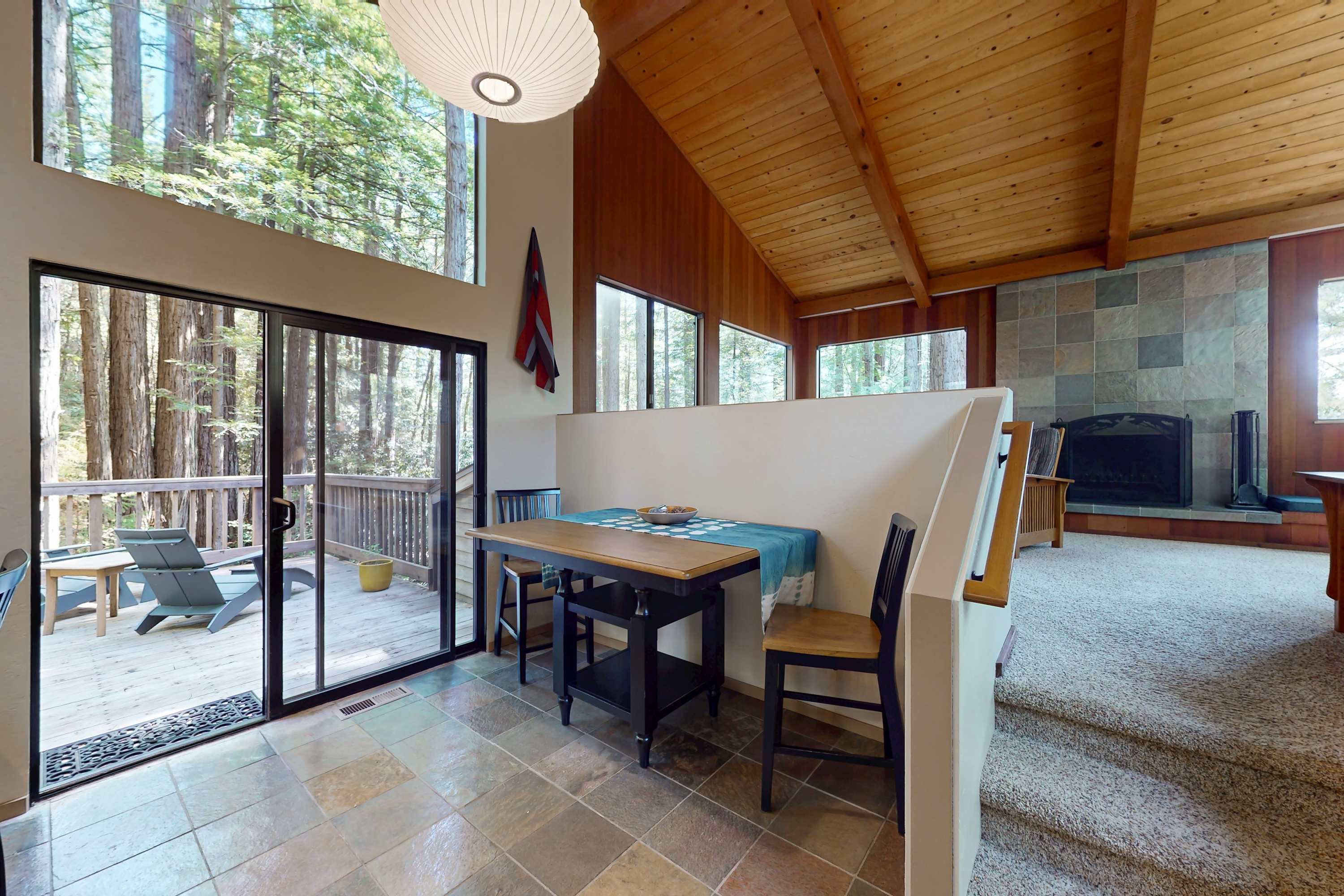 Bright and inviting, this dining area beckons you to savor meals while enjoying views of the surrounding redwoods.