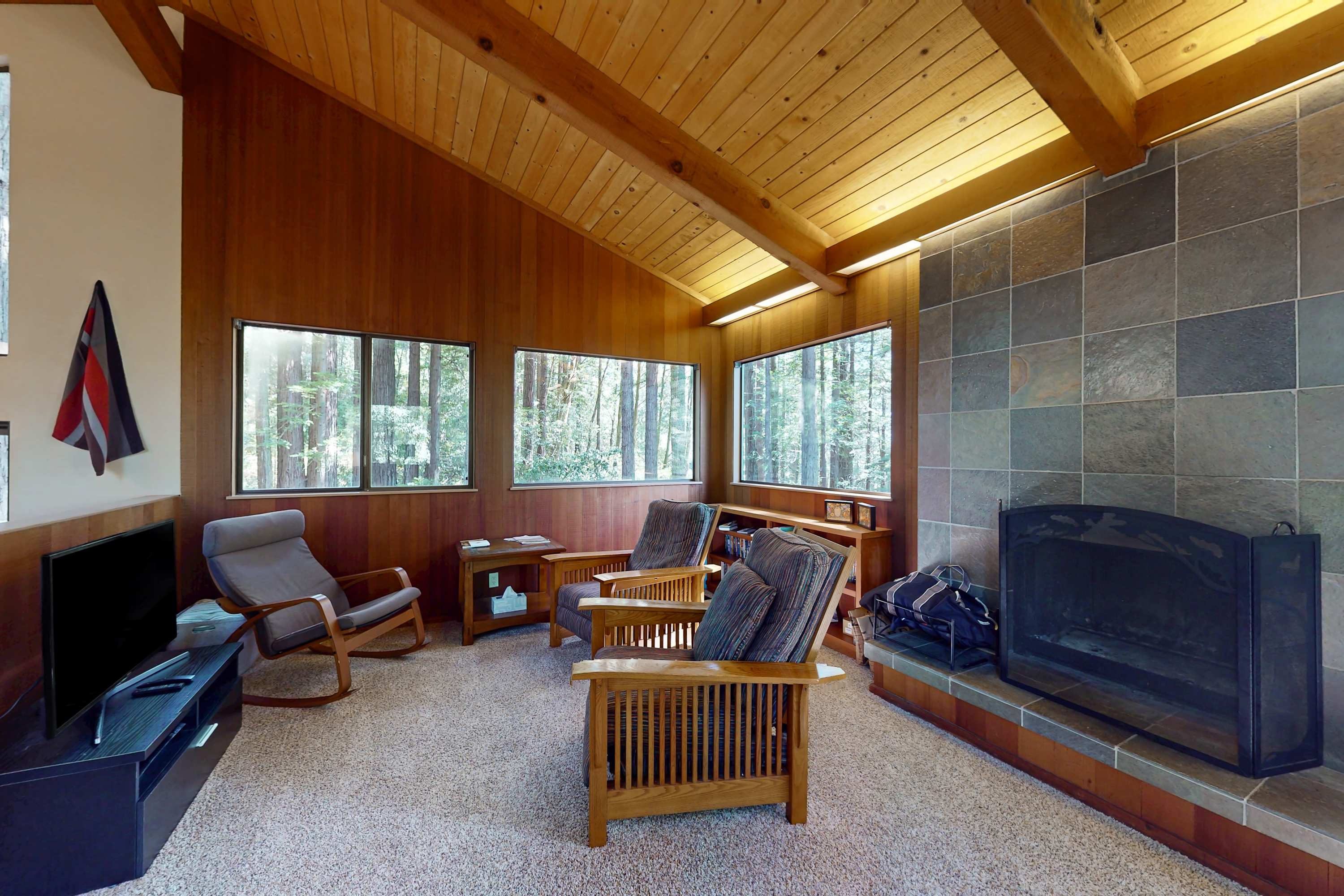 Gather around the fireplace in this tranquil living room, where cozy evenings and good conversation come naturally.