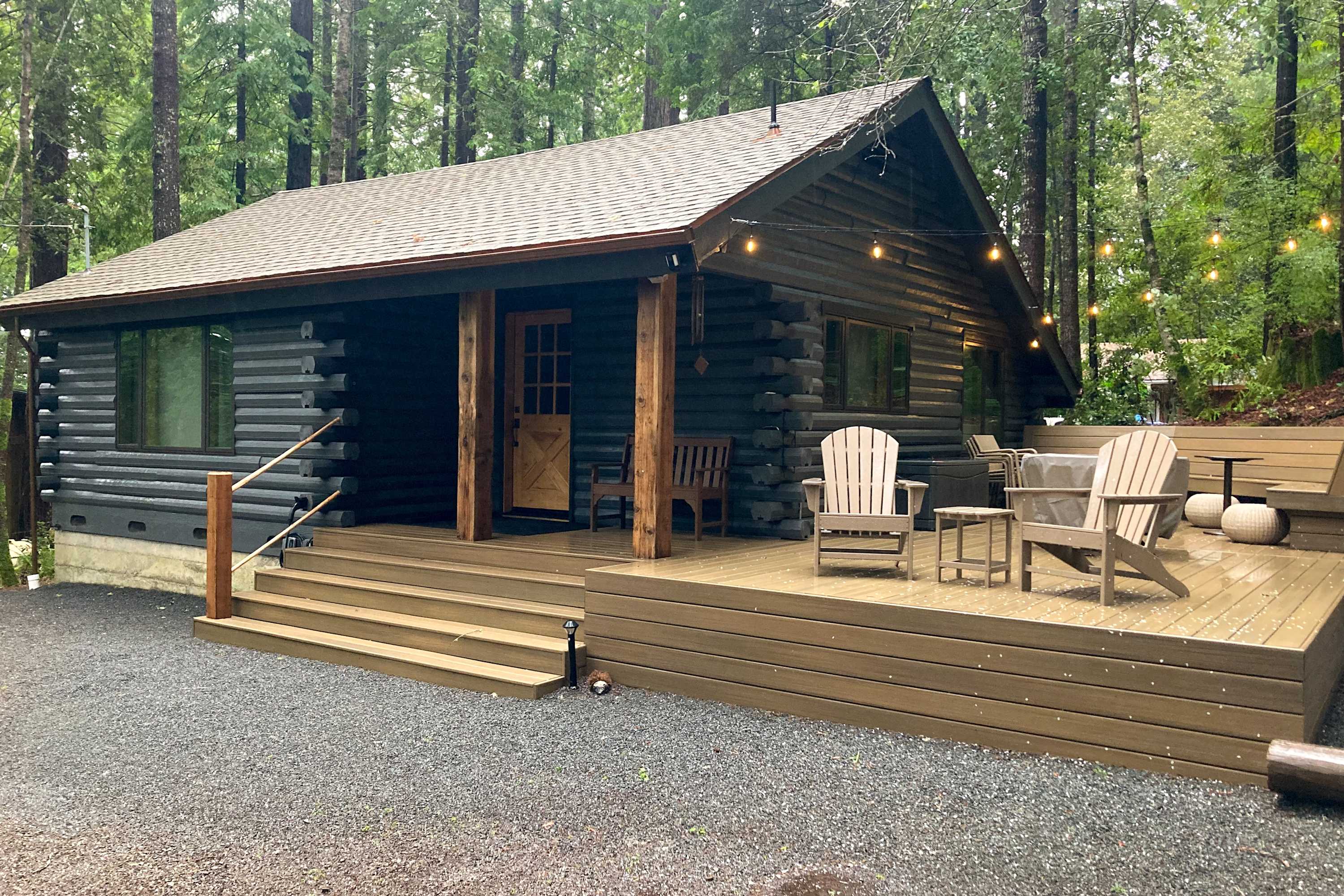 Step onto the inviting deck, where you can sip your morning coffee surrounded by towering redwoods and twinkling outdoor lights.