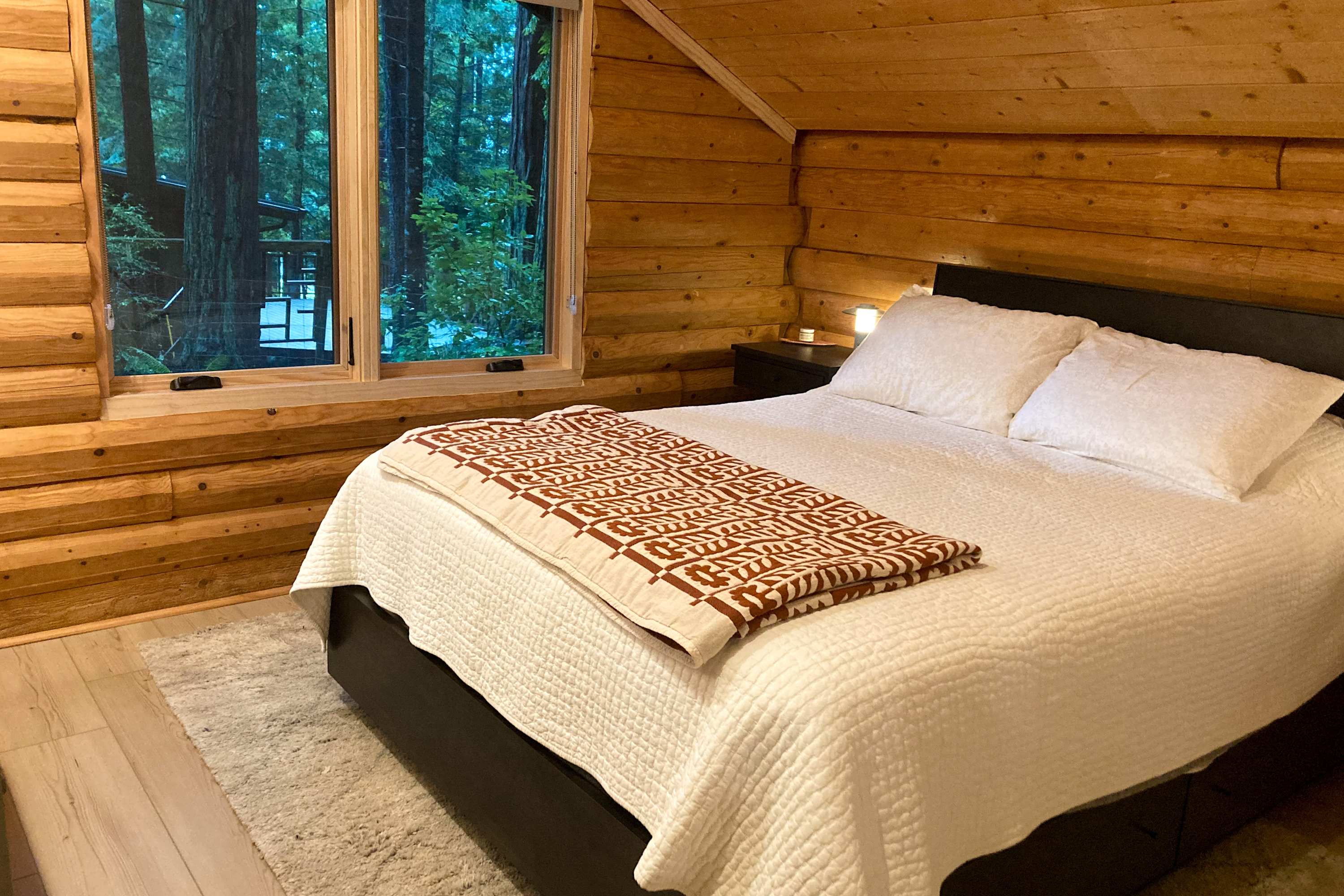 Awaken to the soft glow of morning light in the master bedroom, where nature's beauty is just outside your window.