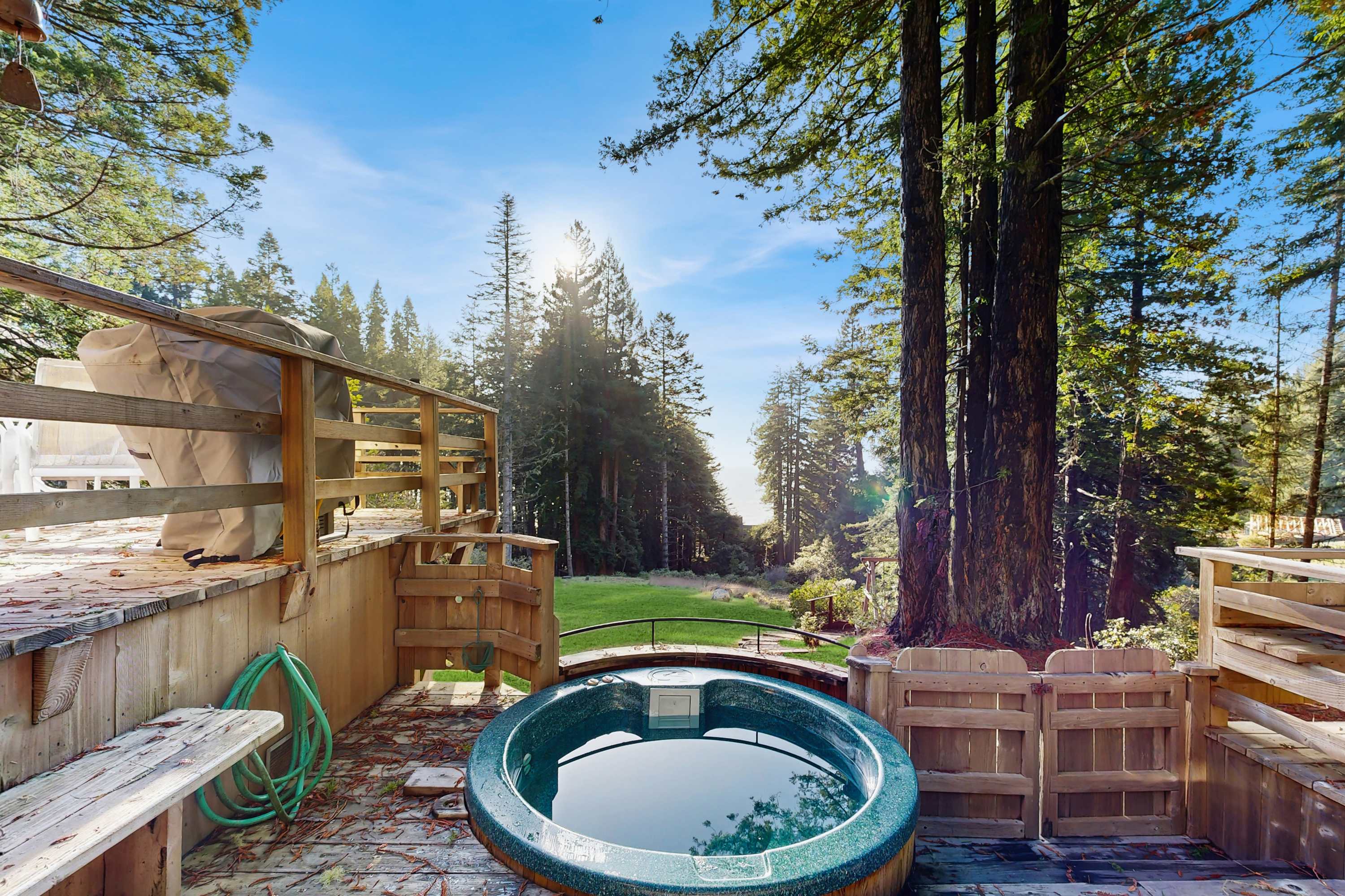 Soak in your private hot tub surrounded by serene redwoods, the perfect spot to unwind after a day of exploration.