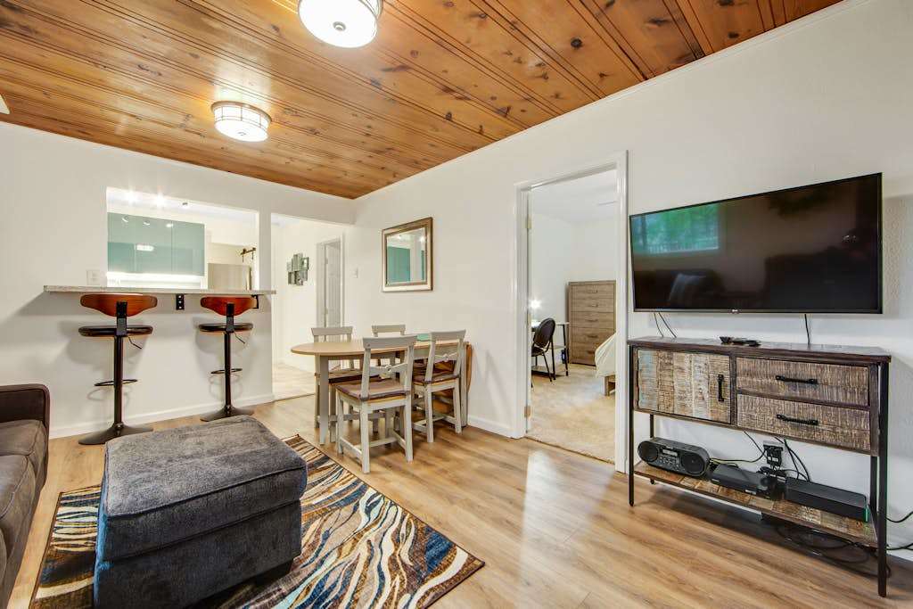 Open-concept living flows effortlessly from the breakfast bar to your entertainment area with a large flat-screen TV — ideal for cozy redwood evenings indoors.