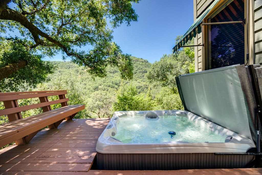 Soak under the oaks in your private hot tub while rolling green hillsides stretch to the horizon — pure Sonoma bliss.