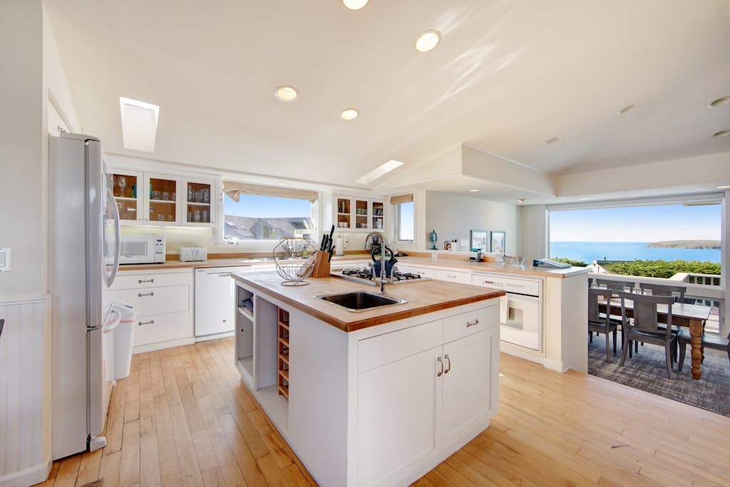 Cook like a local in this bright, open kitchen featuring a center island with wine storage and ocean views.