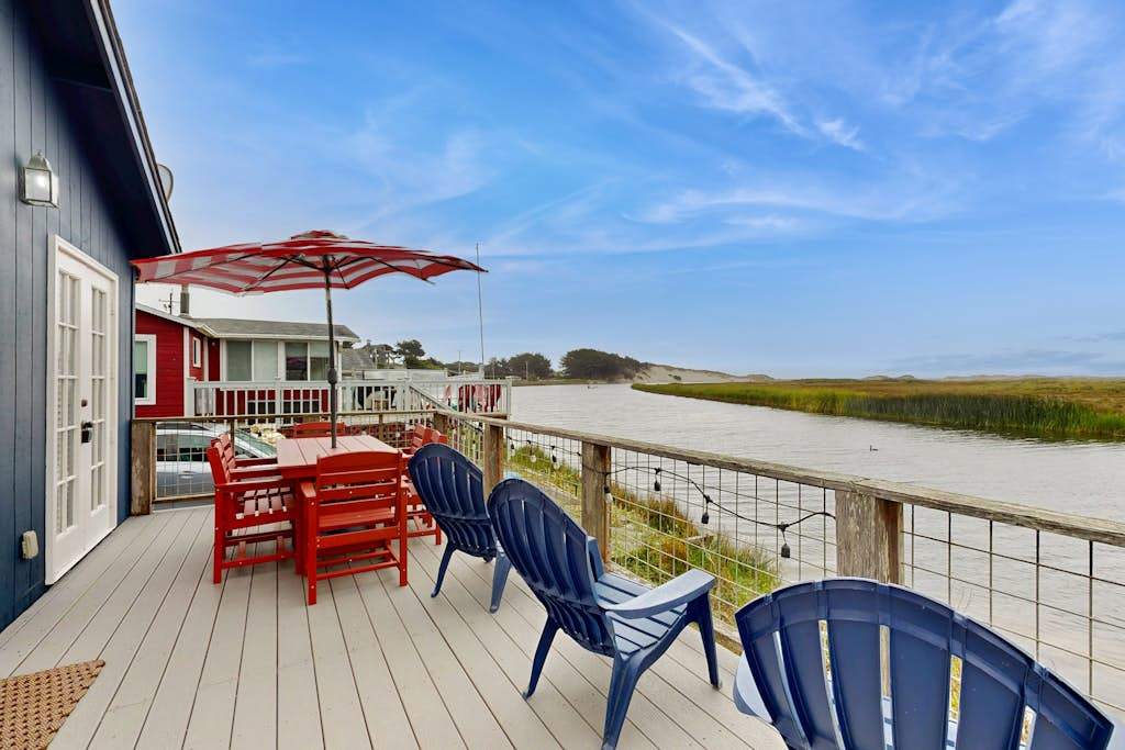 Dine al fresco on your private waterfront deck overlooking Bodega Bay's shimmering estuary, with Sonoma Coast hills in the distance.