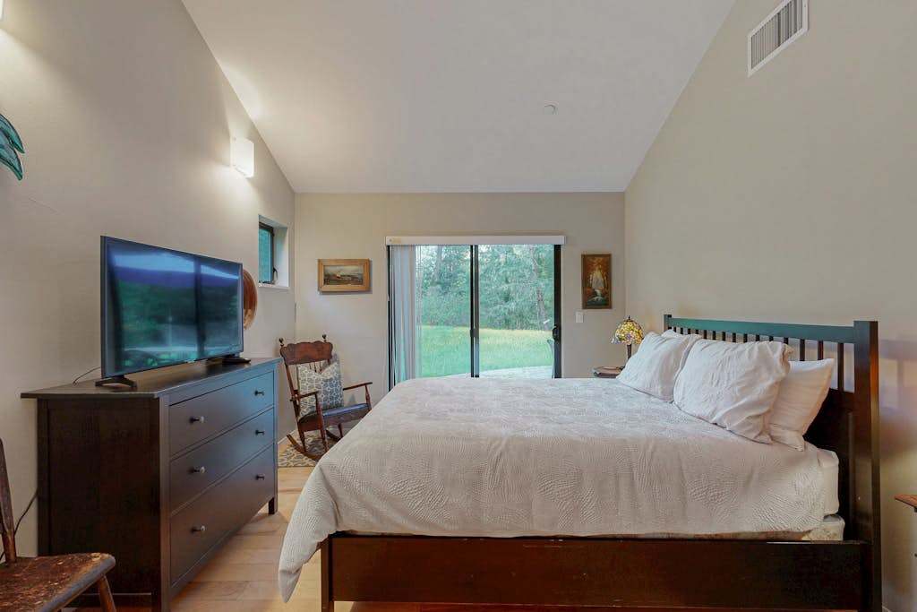 Retreat to your serene master bedroom with a queen bed and sliding glass doors that open to the private garden.