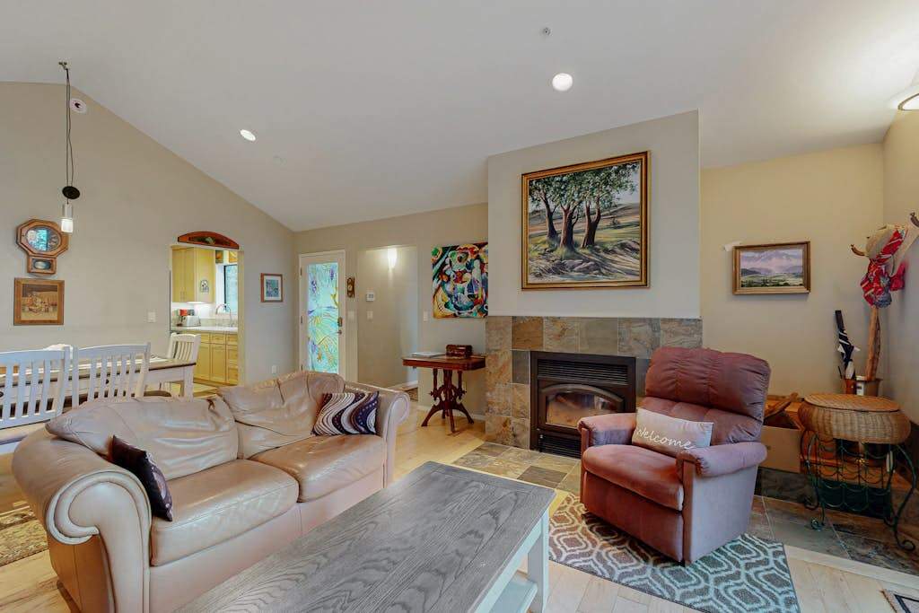 Gather your group around the stone fireplace after a day exploring Sonoma County vineyards — plush seating and local art set the scene.