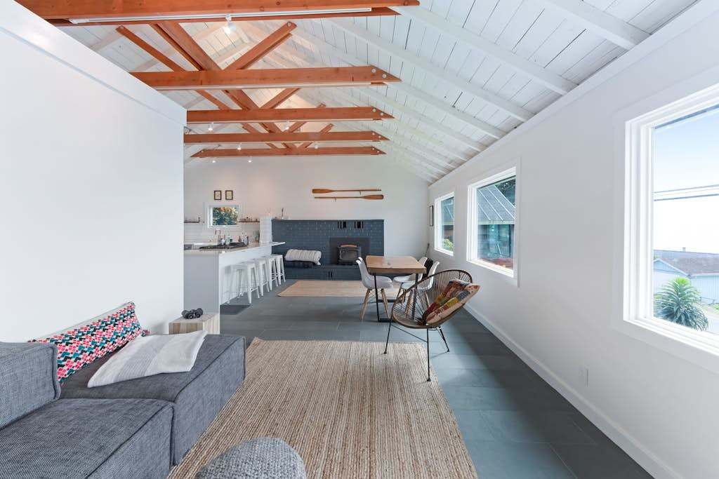 Bright open-concept living flows from the cozy lounge through to your dining area, all under stunning exposed beam ceilings.