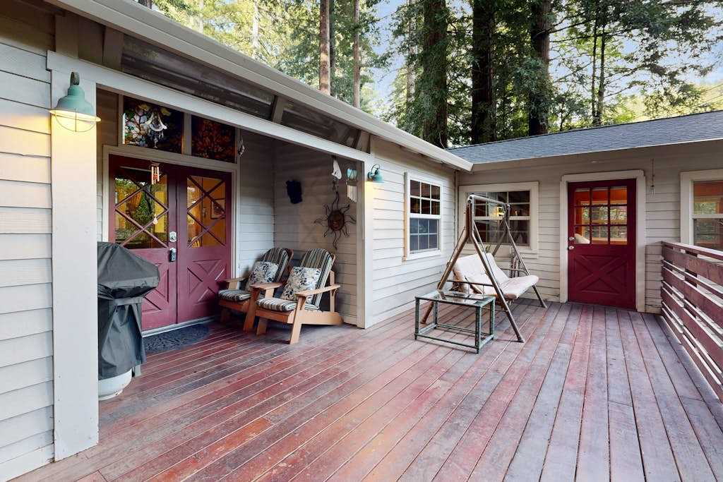 Step onto your spacious redwood deck with a porch swing, Adirondack seating, and a covered BBQ grill for evening cookouts.