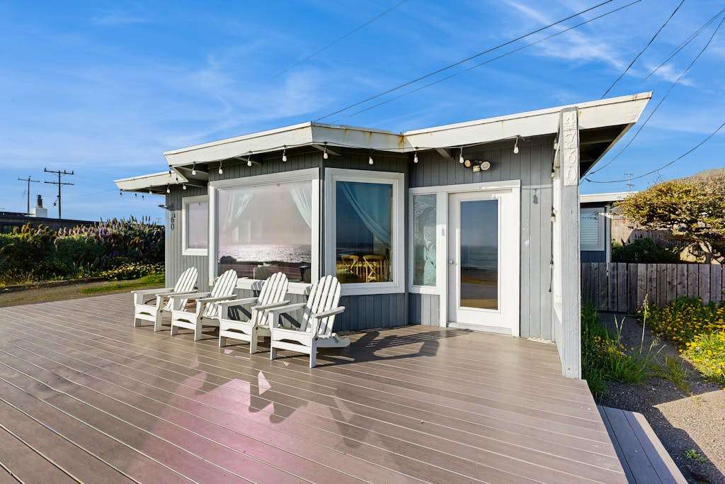 Relax on your private sun-drenched deck with Adirondack chairs and string lights at this Bodega Bay coastal retreat