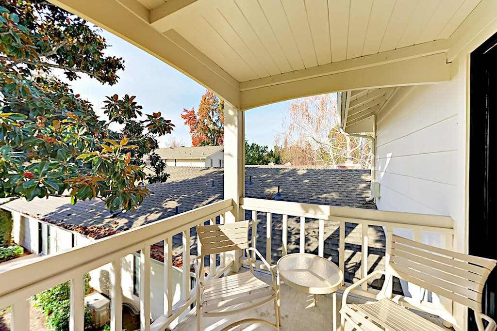 Sip your morning coffee on the covered deck surrounded by mature trees and peaceful resort views at Silverado in Napa wine country