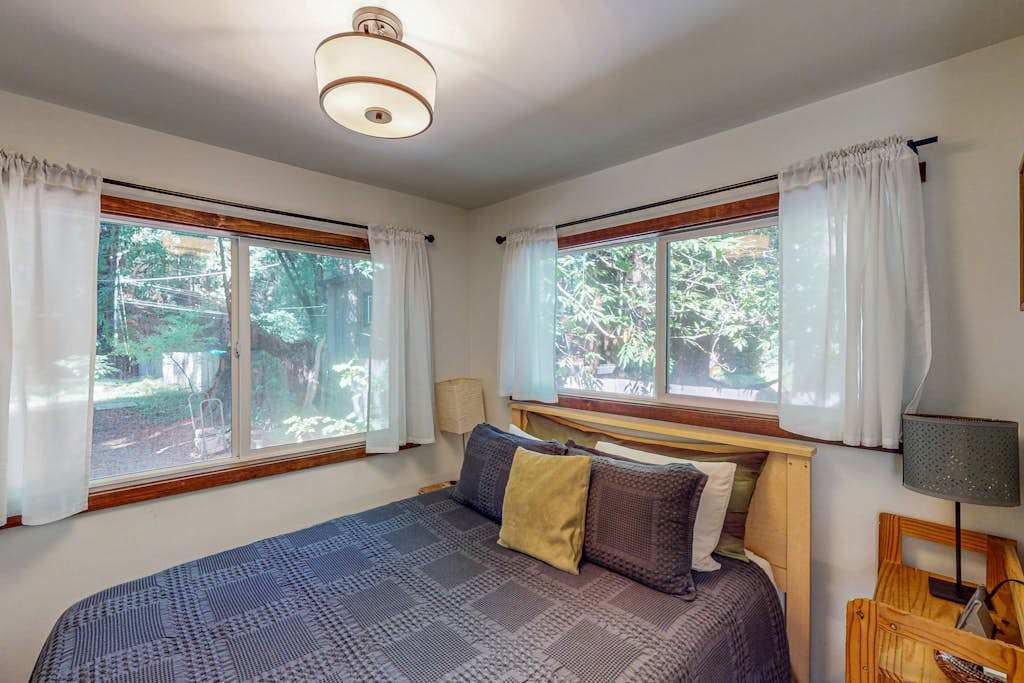 Drift off in your ground-floor queen bedroom wrapped in greenery views — two windows invite the quiet sounds of Cazadero nights.