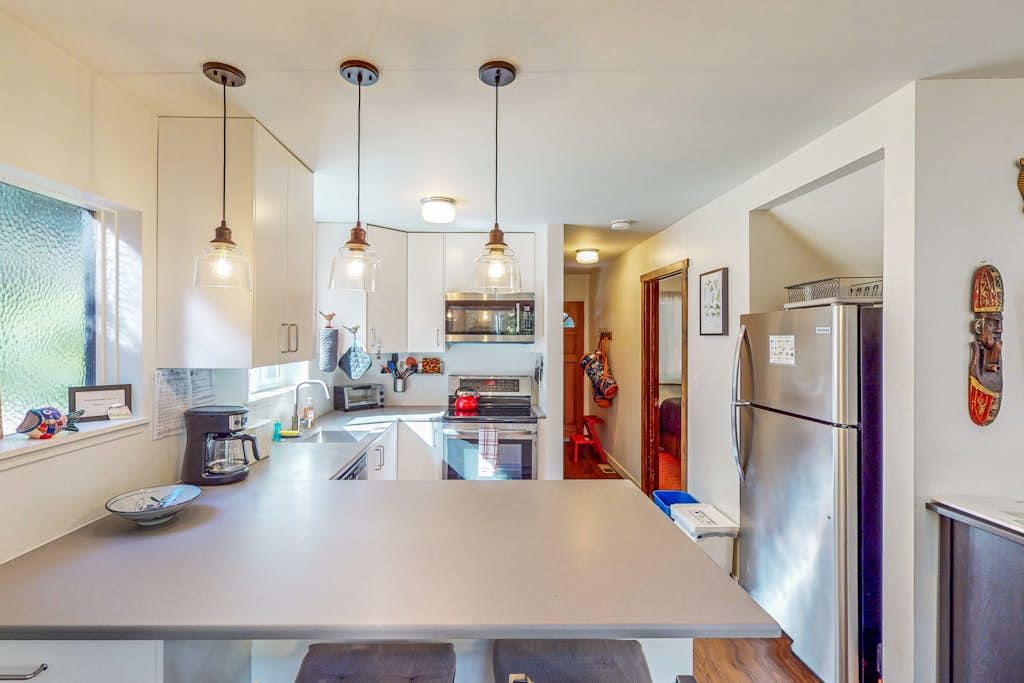 Whip up farm-to-table feasts in your fully equipped kitchen — ample counter space and pendant lighting make cooking feel effortless.