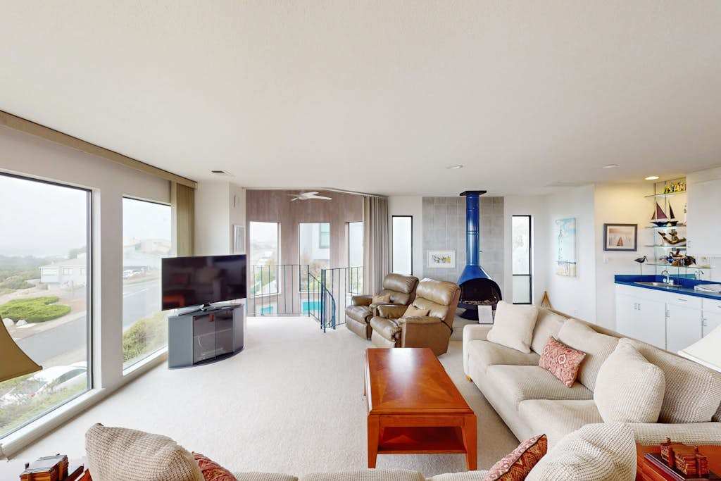 Warm your evenings by the striking blue gas fireplace while Bodega Bay's coastal beauty unfolds through your wraparound windows and balcony