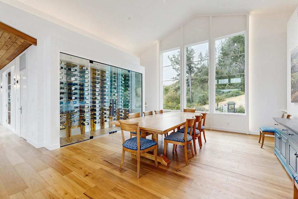Toast your Calistoga getaway at a dining table flanked by a stunning glass-enclosed wine cellar — the perfect stage for your favorite Sonoma County bottles.