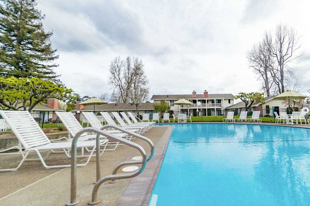 Dive into crystal-clear water surrounded by classic Napa Valley resort architecture — your poolside afternoon is calling.