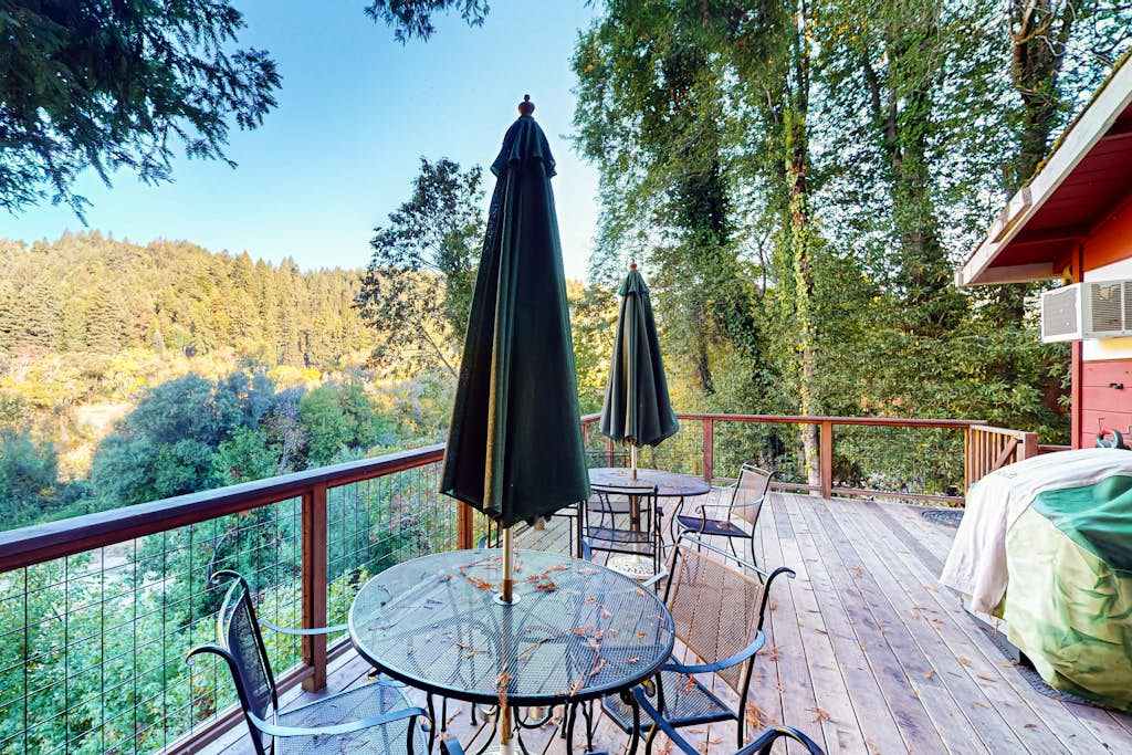 Sip your morning coffee at the elevated deck table while redwood-studded hillsides unfold before you — your private balcony above the Russian River canopy.