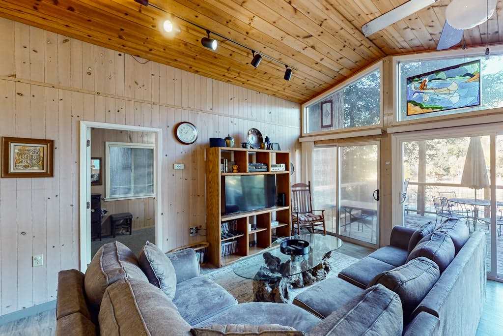 Gather under soaring knotty-pine ceilings where handcrafted stained glass catches the afternoon light — your wine country living room among the redwoods.