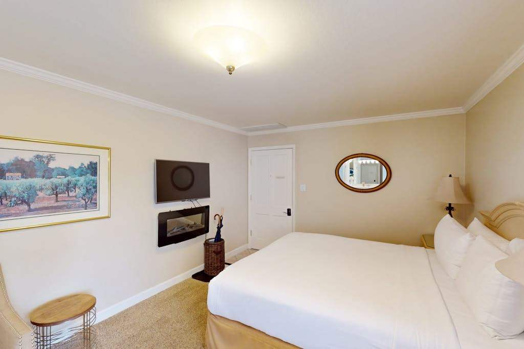 Unwind by the in-room fireplace and flat-screen TV after exploring Napa's acclaimed wineries — your king bed and cozy armchair are ready for you.