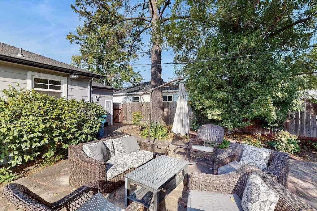 Unwind after a day of Sonoma tastings on your private patio — sink into wicker seating beneath the canopy of a grand shade tree in the enclosed backyard