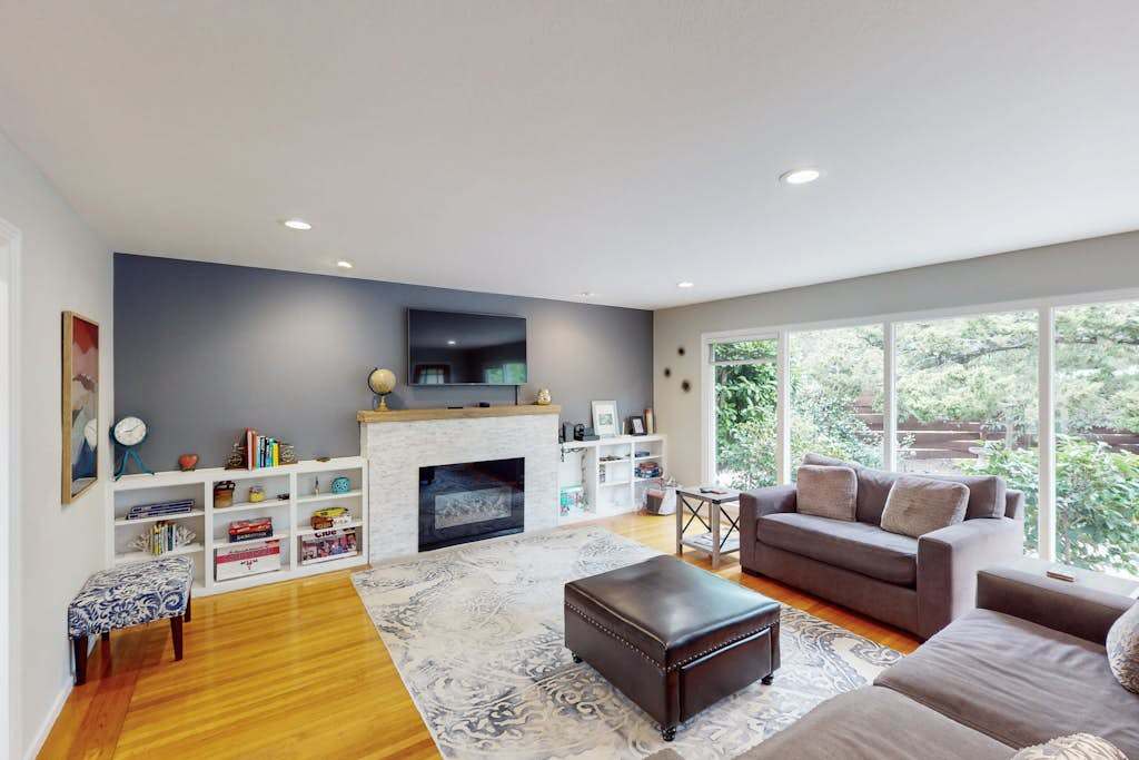 Cozy up by your indoor fireplace with a glass of Sonoma pinot — a wall-mounted TV and stylish accent wall make this the ideal space for quiet evenings in wine country.