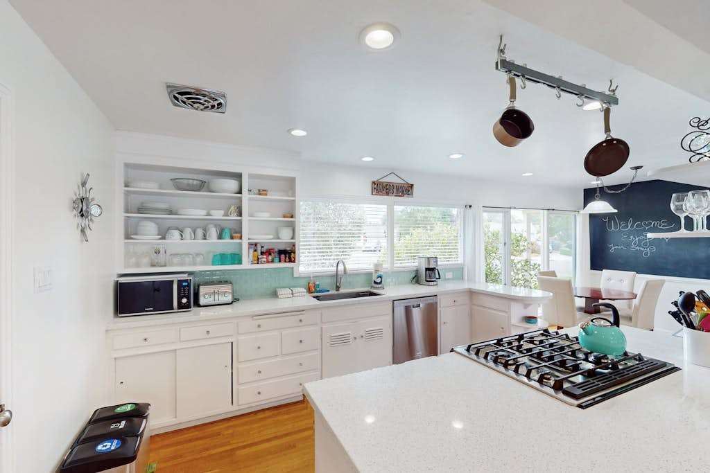 Channel your inner chef in your fully equipped kitchen — a gas cooktop island, open shelving, and hanging copper pans make preparing wine-country-inspired meals a pleasure.