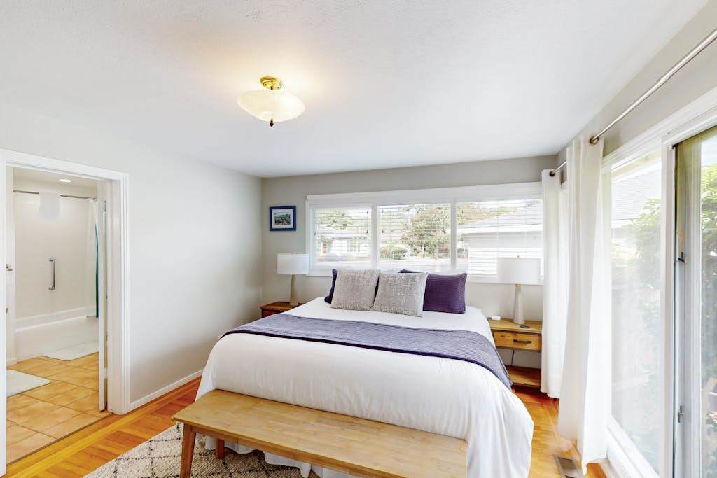 Drift off in your king-size bed with crisp linens and garden views — step through the glass door to your private patio or into the en-suite bath after a day exploring Sonoma.