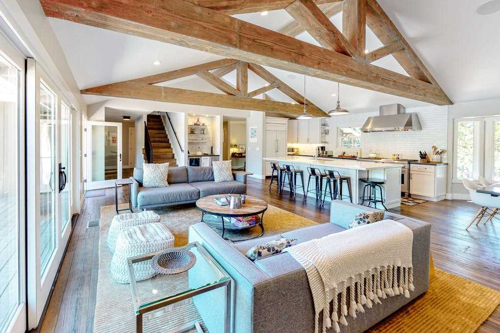 Soaring exposed timber beams crown your open-concept great room, where plush sofas and a chef's kitchen invite long Sonoma Valley evenings with your favorite bottle.
