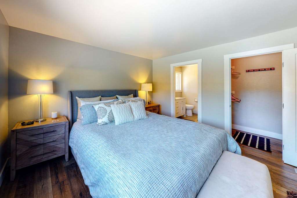 Retreat to your king-size sanctuary with an upholstered headboard, dual nightstands, and direct access to an en-suite bath and walk-in closet — pure Sonoma comfort.