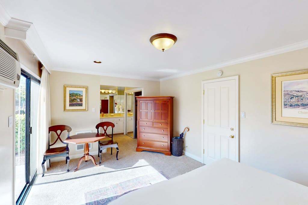 Take in the full layout of your Napa Valley suite — king bed, dining nook, and patio access all in one sunlit space