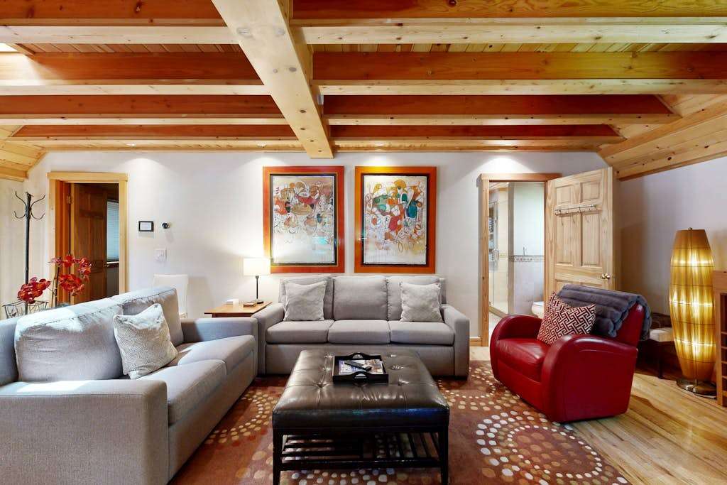 Curl up with a Sonoma County red beneath gallery-worthy art and golden beam ceilings — every angle of your living room invites relaxation.