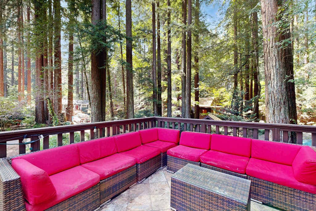 Lounge on your vibrant outdoor sectional as sunlight filters through ancient redwoods — mornings here feel like your own private forest sanctuary near the Russian River.