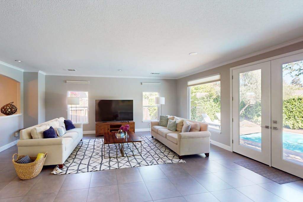 French doors flood your living room with natural light and open directly to the pool — grab a glass of Sonoma red and drift between indoors and out.