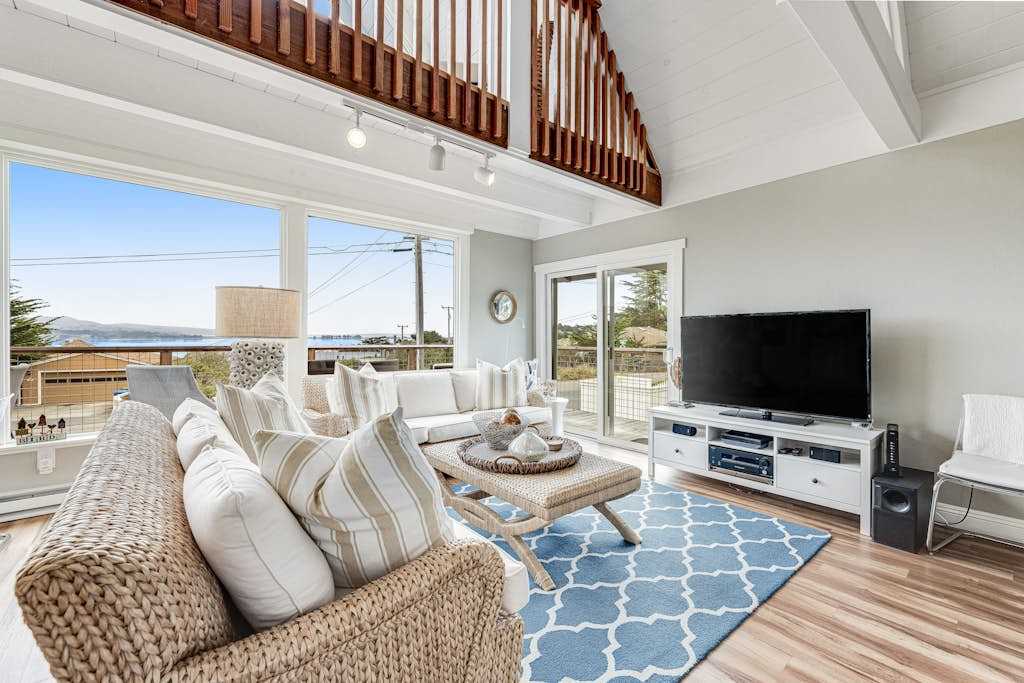 Kick back on the wicker sofa and take in sweeping harbor views through floor-to-ceiling windows — your flatscreen TV is there when the sunsets finally fade.